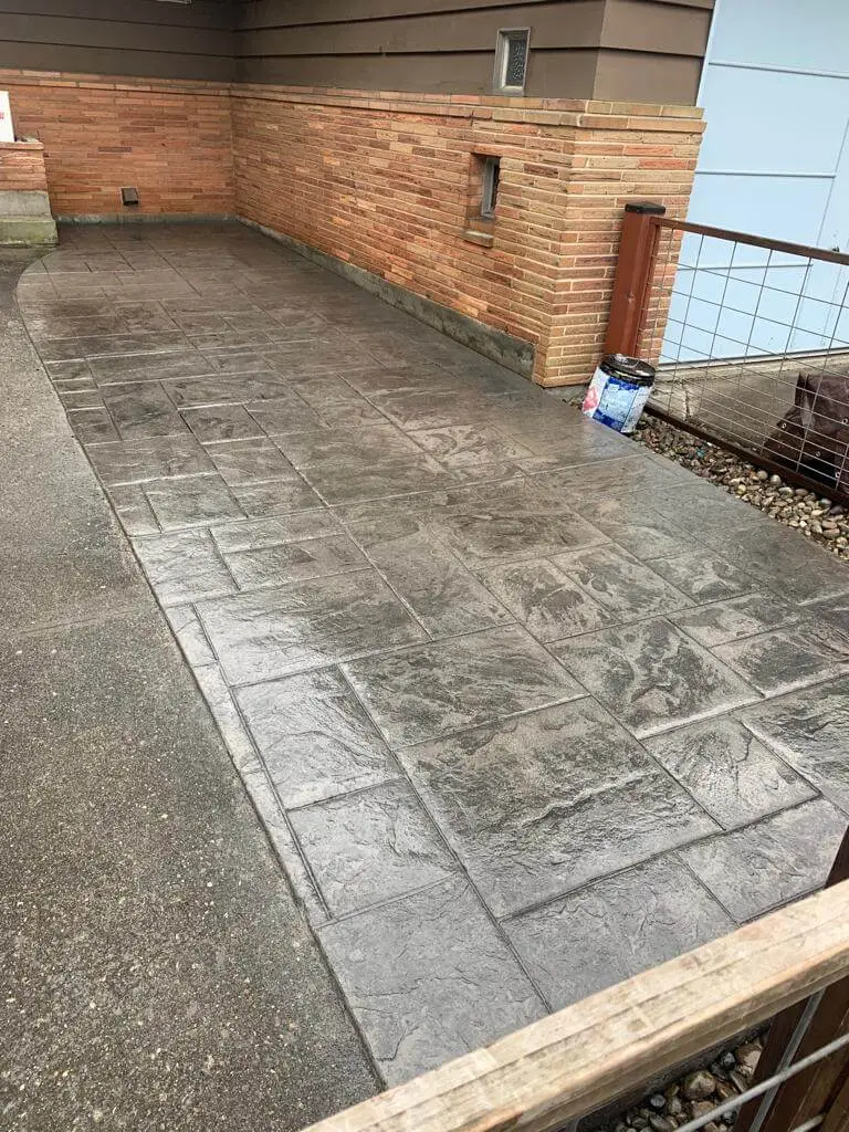 Custom textured concrete walkway in a residential backyard